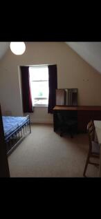 A cozy and well-lit double bedroom featuring a ...