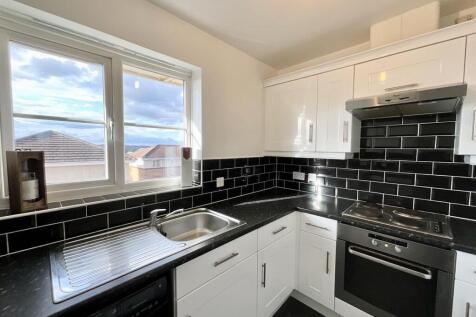 Bright modern kitchen with stylish black tiles...
