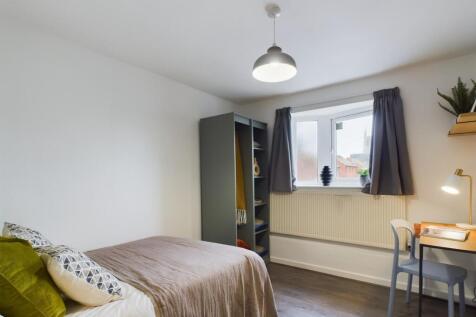 A bright and well-maintained bedroom featuring ...