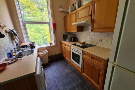 A cozy kitchen featuring wooden cabinetry and m...