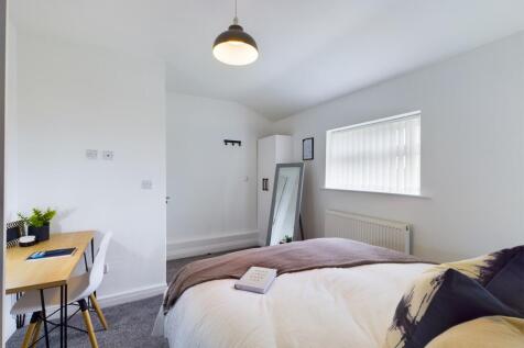 A bright and inviting double bedroom featuring ...