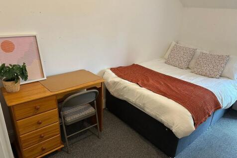 A cozy and well-maintained master bedroom featu...