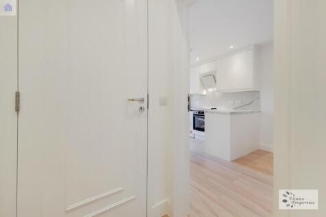 Bright hallway leads to a modern sleek kitchen...