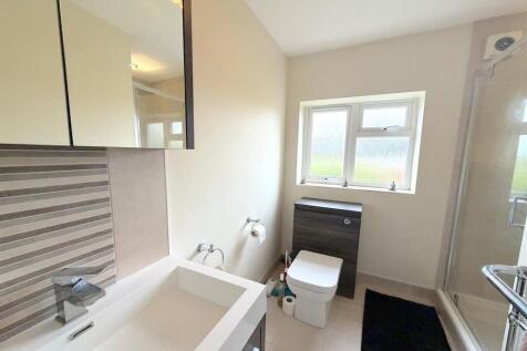 Modern bathroom with natural light and sleek si...