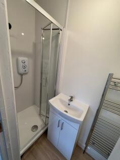 A modern bathroom featuring a sleek shower encl...