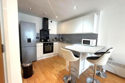 Modern kitchen with breakfast bar and sleek uni...