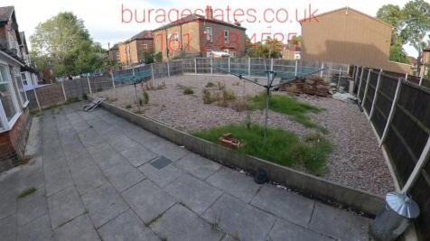 Spacious rear garden with a paved patio area an...