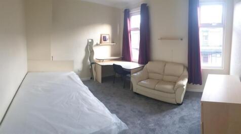 Bright, furnished bedroom with a double bed are...