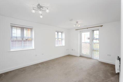 a room with a ceiling fan and windows