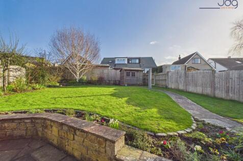 Spacious Garden with a mixture of flags, grass and planting areas