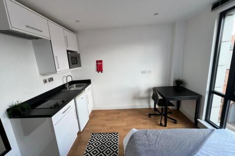 Bright modern studio-style room with a compact ...