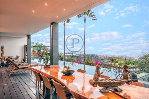 Spacious terrace with a sleek wooden table, overlo