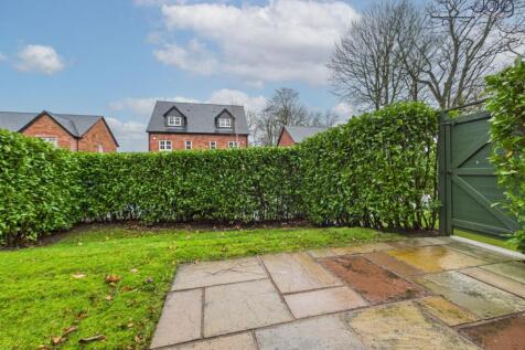 Spacious garden with a mixture of lawn and flagstone