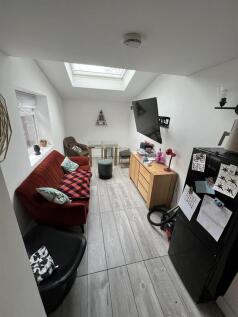 Bright lounge with skylight and stylish sofa...