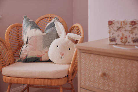 Pillows on chair in corner of children's bedroom