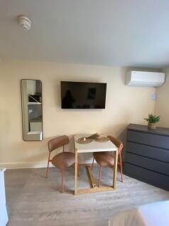 Bright, modern bedroom area with a wall-mounted...