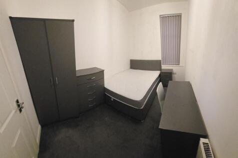 Sleek bedroom with modern furniture and desk...