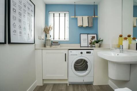 Downstairs there's a combined cloakroom/utility