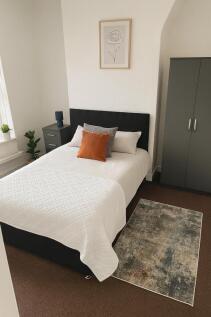 A cozy, well-maintained bedroom featuring a com...