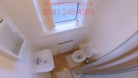 Compact, well-kept bathroom with a white sink, ...