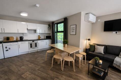 Bright open-plan kitchen with modern lounge are...