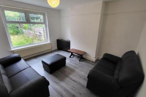 Bright, simply furnished living room with large...