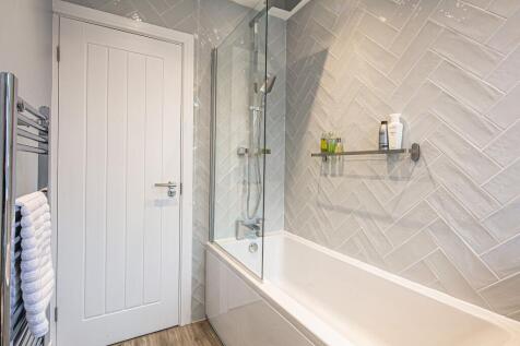 Modern bathroom with a spacious bathtub, sleek ...