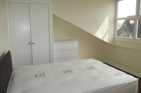 Bright, neatly presented bedroom with a large w...