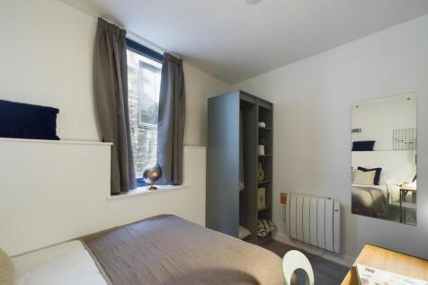 A bright and inviting double bedroom with moder...