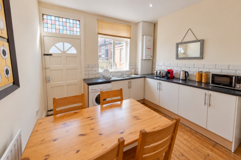 Cozy Sunlit Galley Kitchen and Dining Room