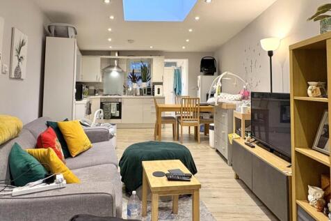 Bright, modern open-plan living area with conte...