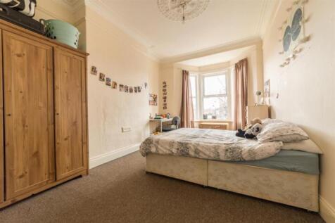 A spacious and inviting double bedroom with goo...