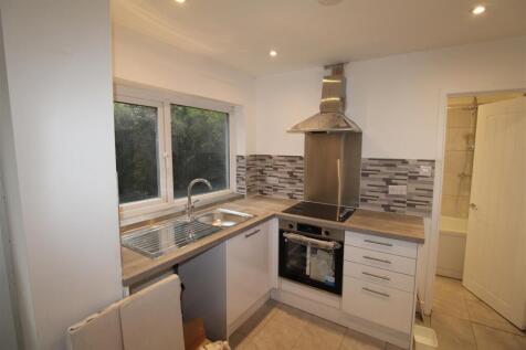 Modern kitchen with sleek white cabinetry...