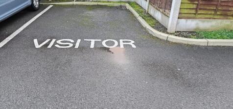 Marked visitor parking space in a residential c...