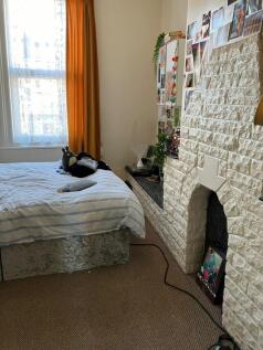A bright and inviting double bedroom featuring ...