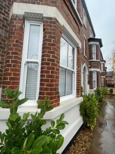 Attractive red-brick terraced frontage with whi...