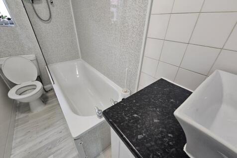 A clean and well-maintained bathroom with a bat...