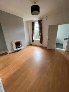 Bright living room with wooden floors and featu...