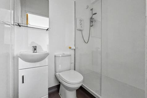 Bright, modern bathroom with a walk-in shower, ...