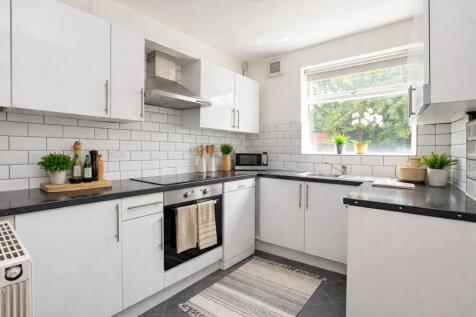 Bright modern kitchen with sleek white cabinets...