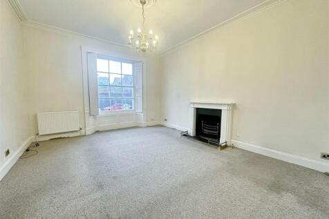 Bright spacious lounge with classic fireplace...