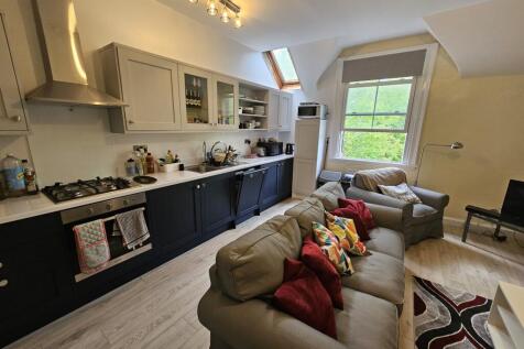 A spacious and well-lit contemporary living roo...