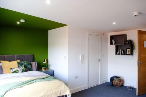 This inviting double bedroom features a cozy at...