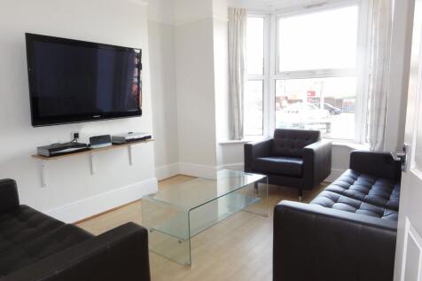 Bright and modern living room featuring three b...