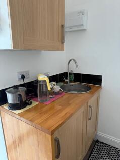 Bright kitchenette with warm wood finishes...