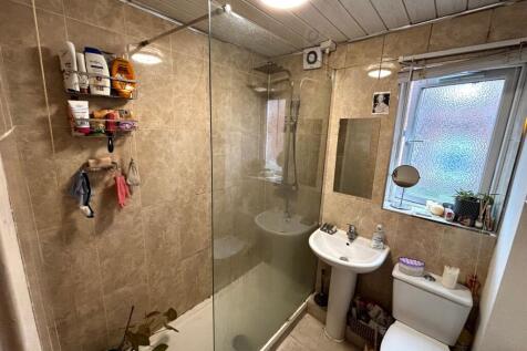 Well-equipped tiled bathroom with a walk-in sho...