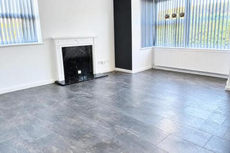 Bright Empty Living Room with Ornate Fireplace.jpg