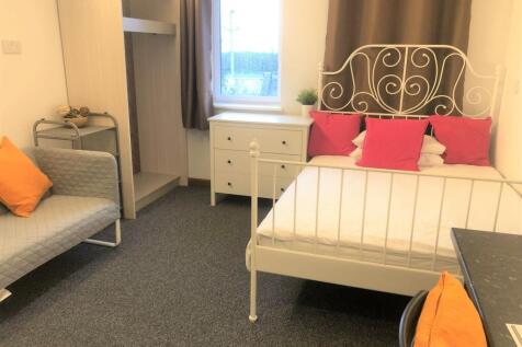 A bright and tidy double bedroom featuring a st...