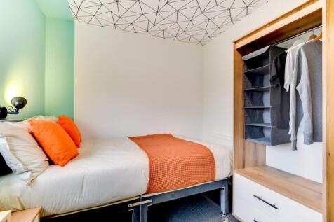 Stylish modern bedroom with geometric ceiling...