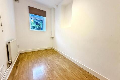 Bright bedroom with wooden floors and window vi...